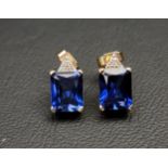 PAIR OF SAPPHIRE AND DIAMOND EARRINGS each of the emerald cut sapphires with small diamonds above,