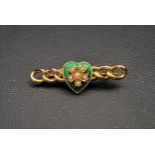 ENAMEL AND SEED PEARL SET GOLD BROOCH the green enamel heart decorated with seed pearl set flower