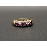 AMETHYST AND DIAMOND DRESS RING the three oval cut amethysts separated by small illusion set