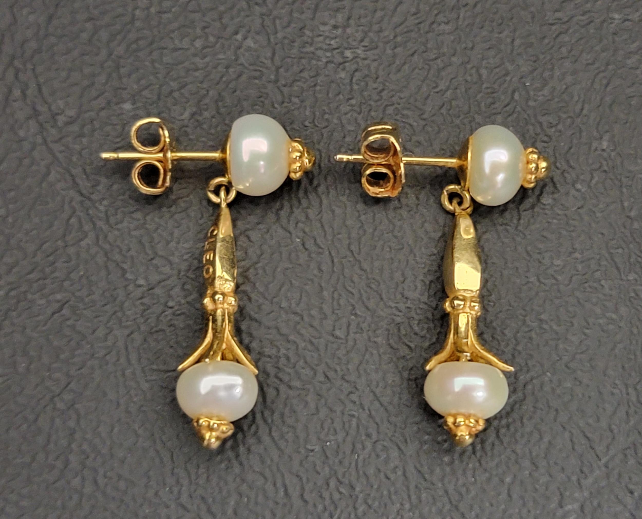 PRETTY PAIR OF PEARL SET FOURTEEN CARAT GOLD EARRINGS BY CLEO the pearl drops on each in shaped