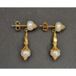 PRETTY PAIR OF PEARL SET FOURTEEN CARAT GOLD EARRINGS BY CLEO the pearl drops on each in shaped