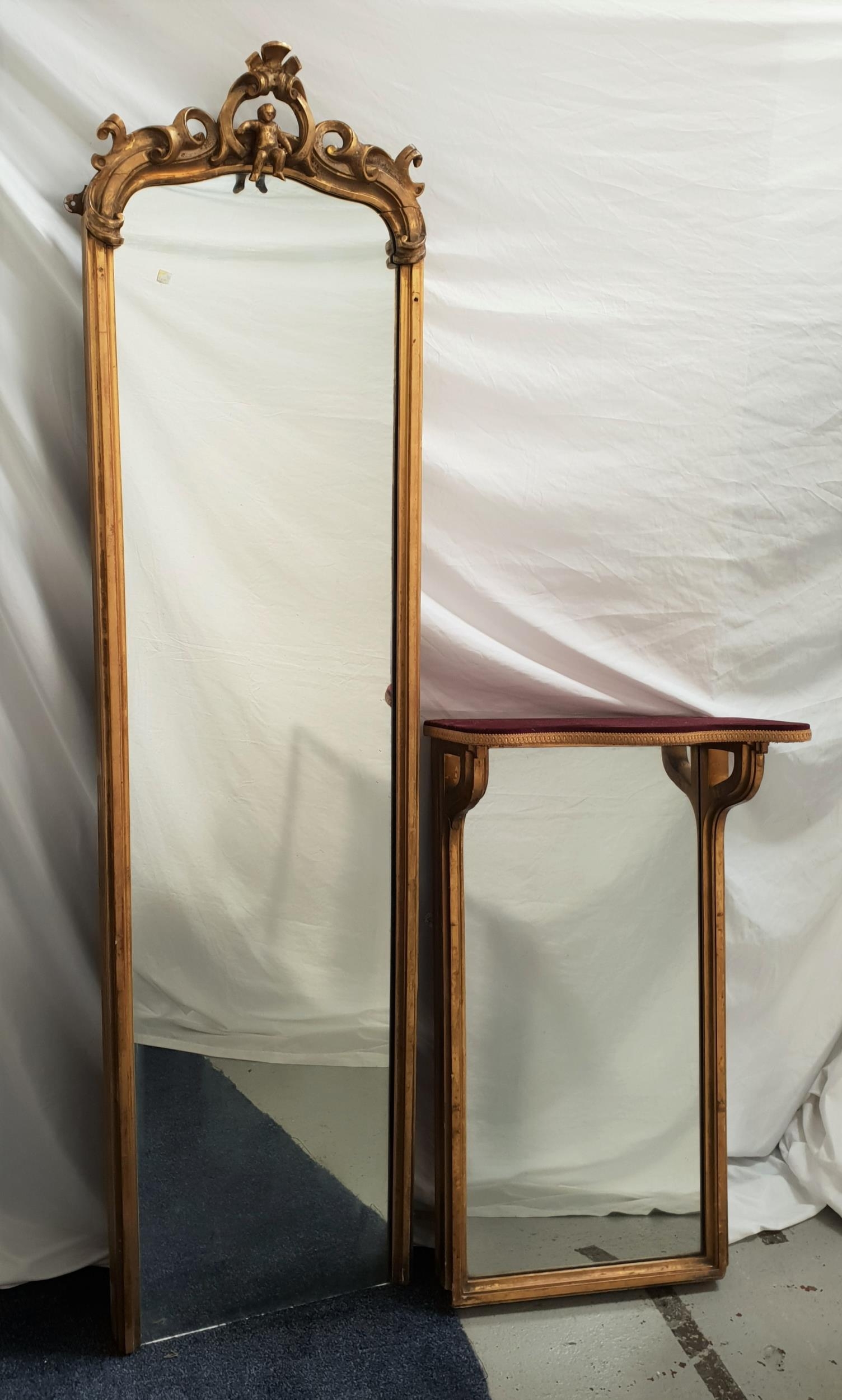 LATE 19th CENTURY PIER MIRROR with a plain plate and carved giltwood frame surmounted with scrolls