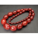 LARGE GRADUATED AMBER BEAD NECKLACE the largest bead approximately 3cm long and the smallest 1.1cm