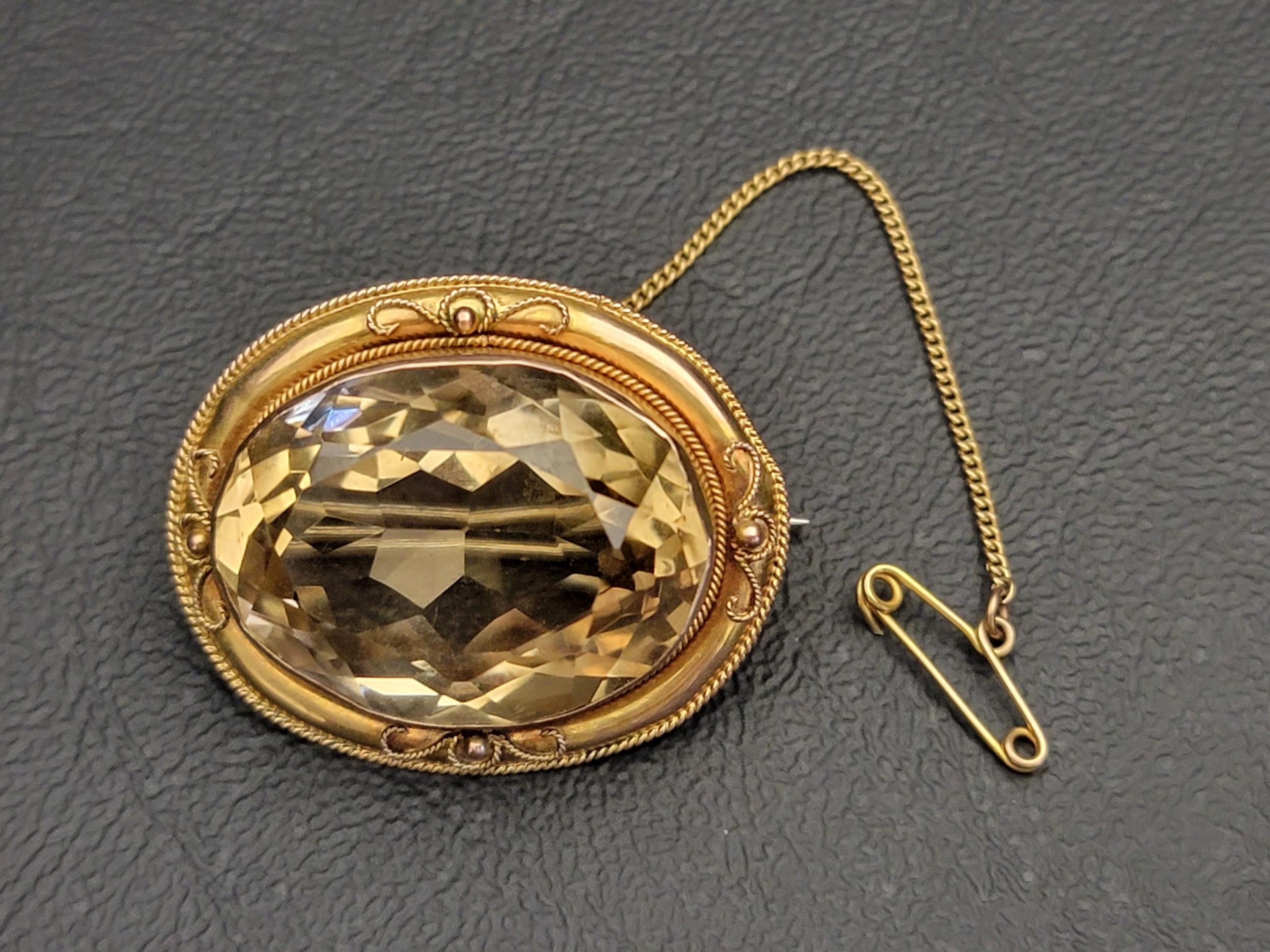 LARGE CITRINE SET BROOCH in nine carat gold, the central oval cut citrine measuring approximately