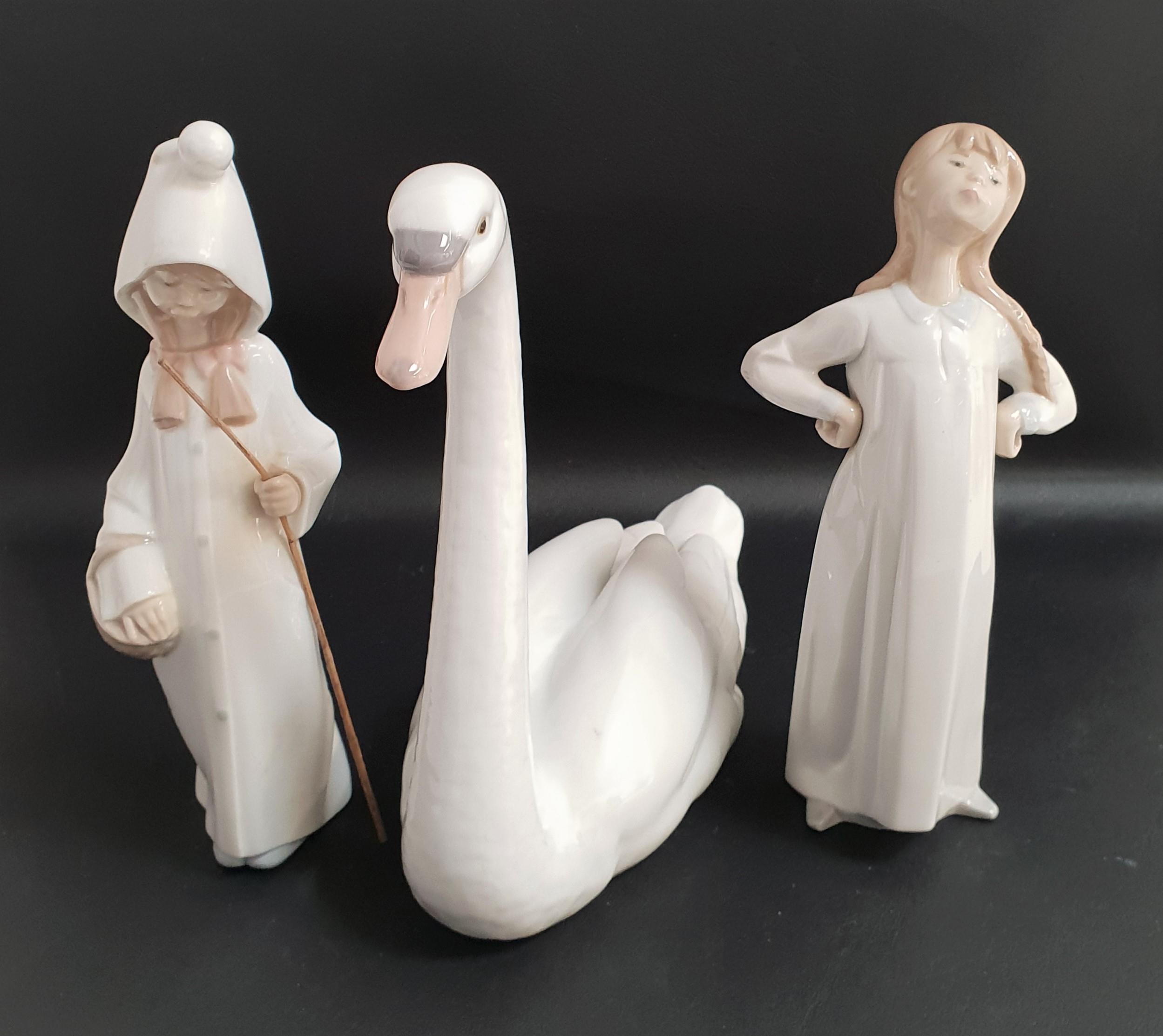 THREE LLADRO FIGURINES comprising Graceful swan 5230, 21.5cm high, Shepherd girl 4678, 21.5cm high