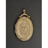 NINE CARAT GOLD LOCKET PENDANT with scroll decoration overall, total weight approximately 5.9 grams