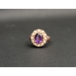 AMYTHYST AND PEARL CLUSTER RING the central oval cut amethyst approximately 1ct in a twelve pearl