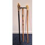 WALKING CANE with a resin parrot handle, 91cm high, an ebonised walking cane with a resin wolf