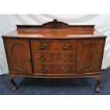 MAHOGANY BOW FRONT SIDEBOARD with a carved and shaped raised back above three central drawers