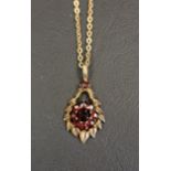 GARNET CLUSTER PENDANT in shaped nine carat gold mount and on nine carat gold chain, total weight