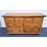 TEAK AND CROSSBANDED LARGE CHEST OF DRAWERS with a panelled top above four short frieze drawers