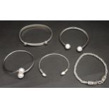 SELECTION OF FIVE SILVER BRACELETS comprising two stone set open cuff bangles, a pearl set open cuff