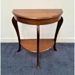 MAHOGANY DEMI LUNE SIDE TABLE with a moulded top on shaped supports with a shelf below, 70cm high