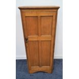 1930s NARROW OAK CABINET with a moulded top above a panelled door opening to reveal a shelved