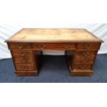 MAHOGANY KNEEHOLE DESK now lacking the inset leather top, above an arrangement of nine panelled