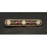 PRETTY OPAL AND RUBY NINE CARAT GOLD BAR BROOCH the pierced brooch with scroll detail, 3.8cm wide