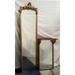 LATE 19th CENTURY PIER MIRROR with a plain plate and carved giltwood frame surmounted with scrolls