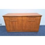 MEREDEW TEAK SIDE CABINET with two frieze drawers above two pairs of cupboard doors, standing on a