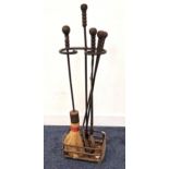 EARLY 20th CENTURY FIRE IRON SET comprising poker, tongs, shovel and brush in a shaped stand, all