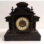 VICTORIAN BLACK SLATE MANTLE CLOCK of architectural outline with a circular brass and enamel dial