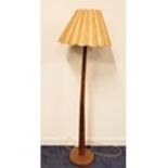 TEAK STANDARD LAMP raised on a circular base with a tapering column and scalloped shade, 153cm high