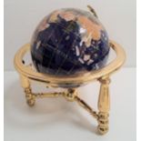 SPECIMEN STONE TERRESTRIAL GLOBE on a brass stand, 32cm high