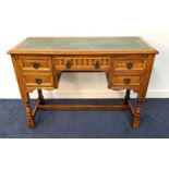 OAK KNEEHOLE DESK with a tooled green leather inset top above an arrangement of five carved and