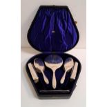 GEORGE V SILVER TRAVELLING DRESSING TABLE SET comprising a hand mirror, four brushes and a comb, all