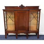 MAHOGANY BREAKFRONT DISPLAY CABINET with a carved and shaped raised mirror back above a central