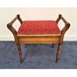 EDWARDIAN MAHOGANY PIANO STOOL with a lift up padded seat flanked by turned handles, standing on