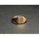 NINE CARAT GOLD SIGNET RING the rectangular top with decorative engraving to one corner,