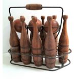 VINTAGE TEAK BOWLING SET comprising three balls and nine shaped skittles, contained in a metal frame