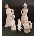 FOUR NAO FIGURINES comprising boy with a fly swatter, 29cm high, girl with a torn nightgown, 29cm