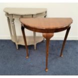 WALNUT D SHAPED HALL TABLE with a wavy edge and standing on slender cabriole supports, 72.5cm