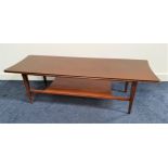 TEAK OCCASIONAL TABLE with a shaped rectangular top and shelf below, standing on tapering