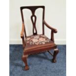 APPRENTICE CHILD'S MAHOGANY ARMCHAIR with a central pierced splat and shaped arms above a floral