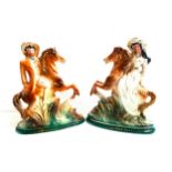 PAIR OF EARLY 20th CENTURY BONESS POTTERY FIGURES depicting Buffalo Bill and Annie Oakley, both on