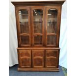 CHERRY ILLUMINATED SIDE CABINET with a moulded pediment above three glass doors and side panels with