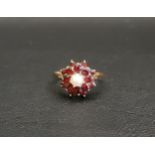 GARNET AND PEARL DRESS RING the central pearl in double garnet surround, on nine carat gold shank,