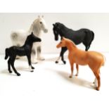 FOUR BESWICK HORSES including a black stallion, 18cm high; black foal, 15cm high; grey Shire, 21cm