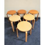 SIX BIRCH STOOLS of laminated construction with circular seats on four shaped supports, 45.5cm