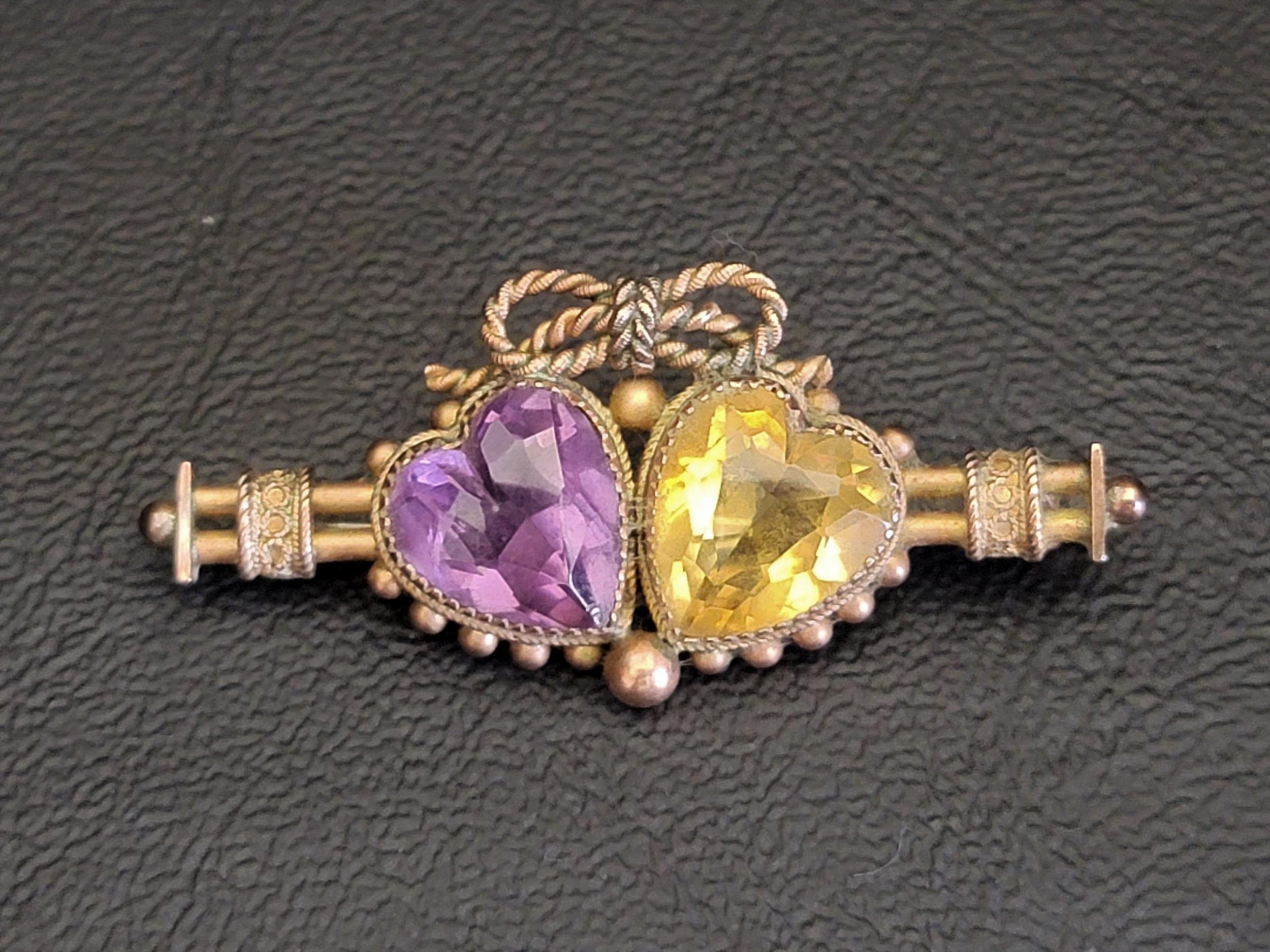 UNUSUAL VICTORIAN AMETHYST AND CITRINE SET BROOCH the two heart shaped gemstones surmounted by