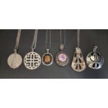 SIX SILVER PENDANTS including a thistle decorated example, one of Art Deco design, a pink topaz