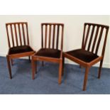 THREE MEREDEW TEAK DINING CHAIRS with slatted backs above drop in seats, standing on turned supports