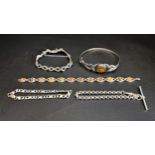 FOUR SILVER BRACELETS AND A BANGLE the bangle and one bracelet set with amber, one bracelet with