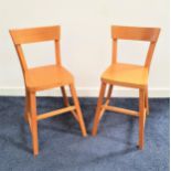 PAIR OF BEECH CHILDRENS STOOLS with shaped backs and solid seats, standing on plain supports (2)
