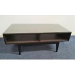 BLACK ASH OCCASIONAL TABLE with a rectangular top above two open shelves, standing on tapering