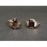 TWO SMOKY QUARTZ SINGLE STONE DRESS RINGS one with round cut gemstone of approximately 6cts, the