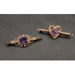 TWO VICTORIAN AMETHYST SET NINE CARAT GOLD BROOCHES one with central amethyst in pierced scroll