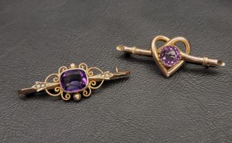 TWO VICTORIAN AMETHYST SET NINE CARAT GOLD BROOCHES one with central amethyst in pierced scroll